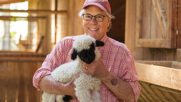 Ken Leaman holding Elliott the lamb