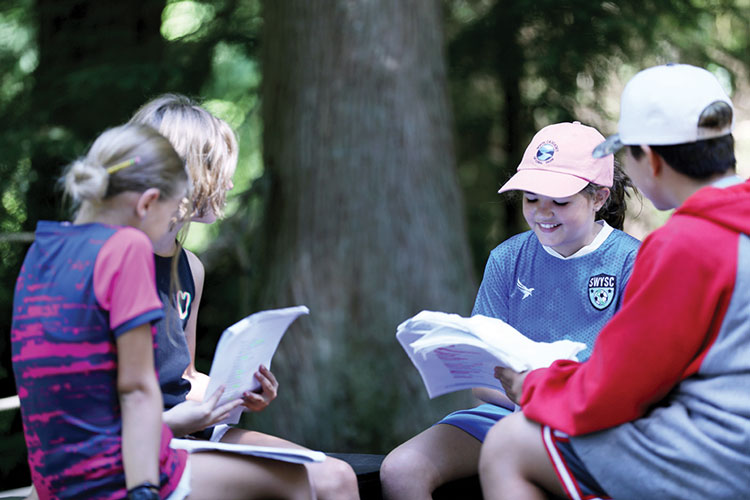 Three young actors reading lines for children's theatre production