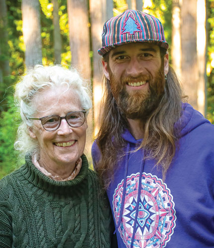 woman and man with colorful cap looking at the camera