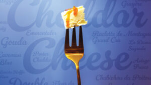 Gold fork with cheese topped with honey in the foreground. Blue background lists different cheese varieties.