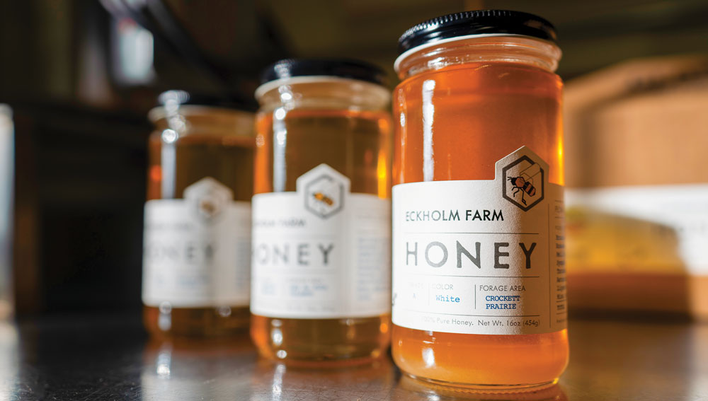 Three jars of honey with the farthest one becoming out of focus