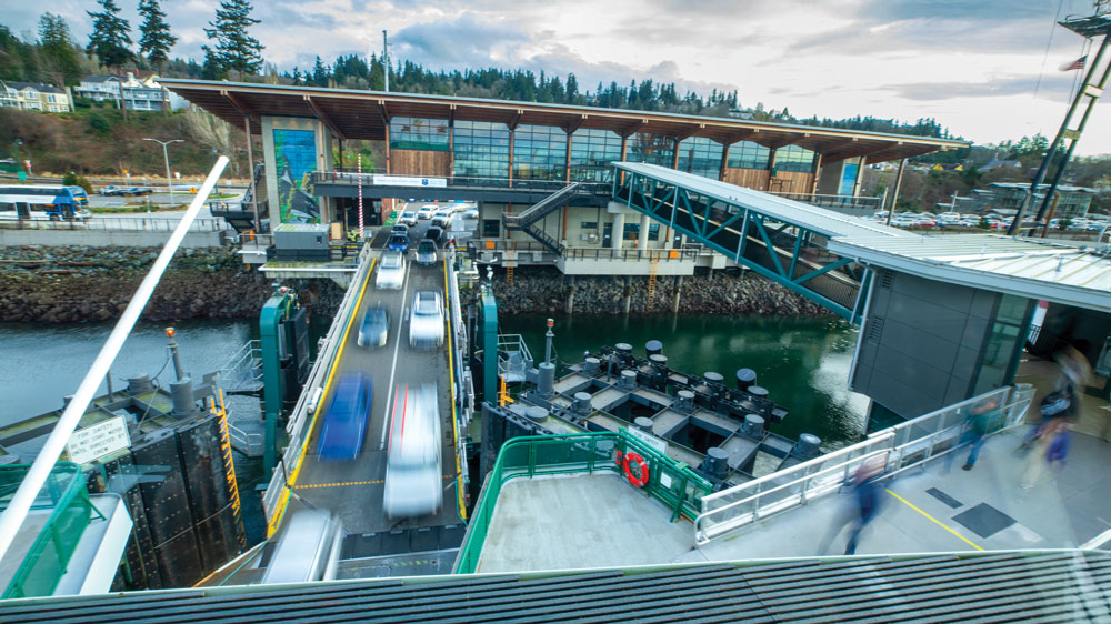 Motion blur of cars driving and people walking to load onto ferry