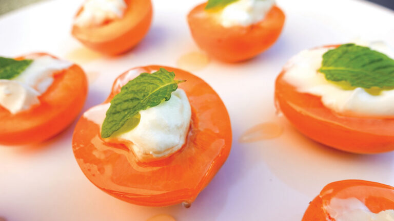 Apricots with white topping and mint leaf