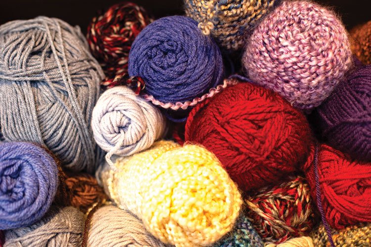 Red, yellow, purple, pink and various color yarns bunched together